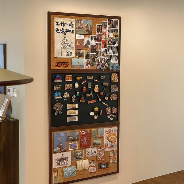 Colorful corkboard with photos, souvenirs, and notes in an office setting.